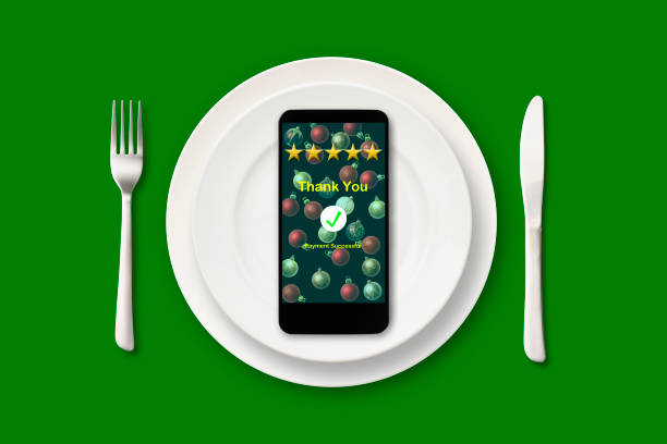 Cashless payment using a smartphone with Christmas meals. Overhead shot of cashless payment using a smartphone with Christmas meals. japan restaurant bill stock pictures, royalty-free photos & images