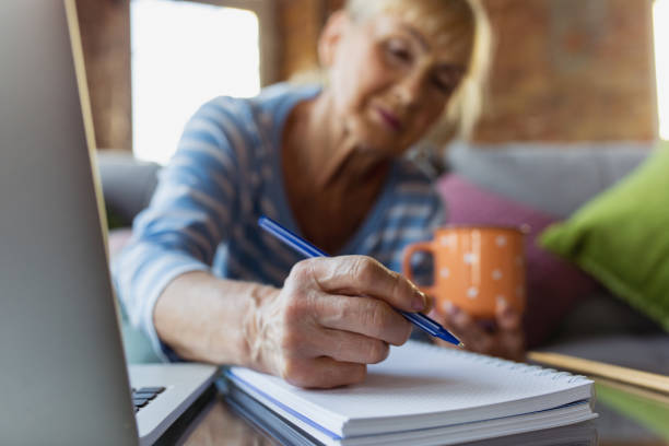 istock Senior woman studying at home, getting online courses 1270570787