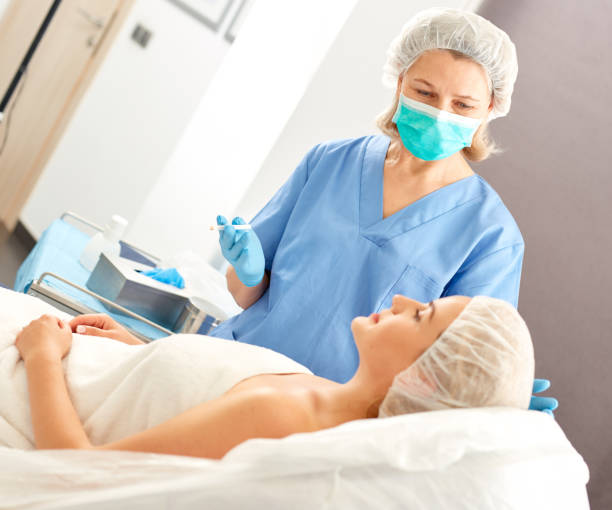 istock Plastic surgeon preparing for operation on woman face 1270572159