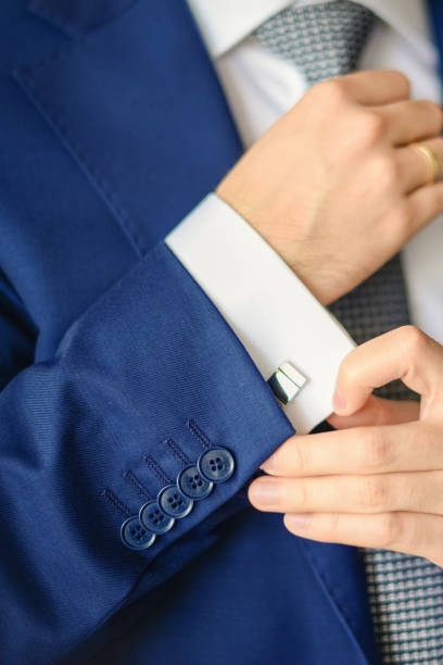 istock Groom or businessman fasten cufflink 1270575056