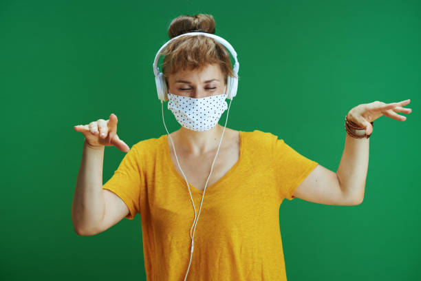 istock student dancing and listening to music isolated on green 1270577894