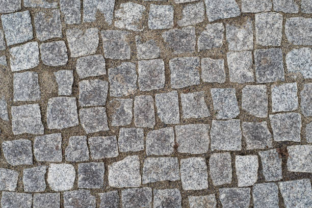 istock Old road paved with granite stones 1270578128
