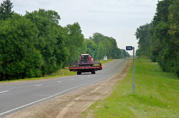 Belarus - August 13, 2013: Harvester rides on the highway in Belarus
