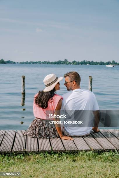 People Relaxing In The Park By The Lake In The Netherlands Vinkeveen Near Amsterdam Vinkeveen Is Mainly Famous For The Vinkeveense Plassen Lakes Of Vinkeveen An Area Of Lakes And Sand Islands East Of The Village Stock Photo - Download Image Now