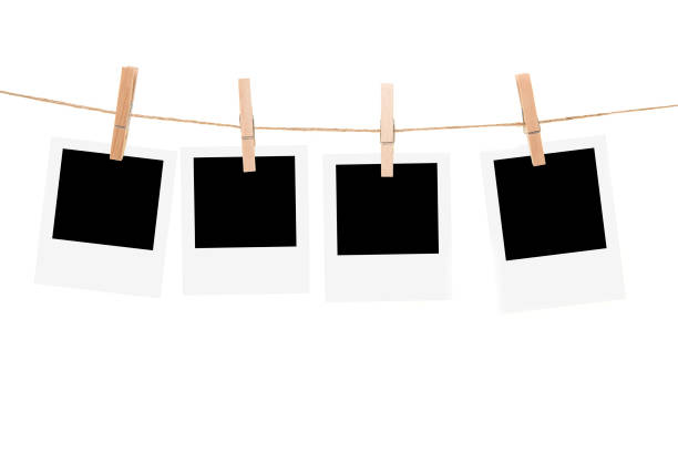 istock Clothesline with empty picture frames and clothespins isolated on a white background 1270582296