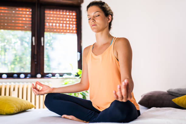 istock Relaxed woman practicing Yoga at home 1270582951