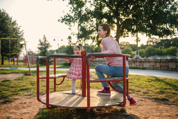 istock Mom and daughter having fun at outdoors playground 1270583096