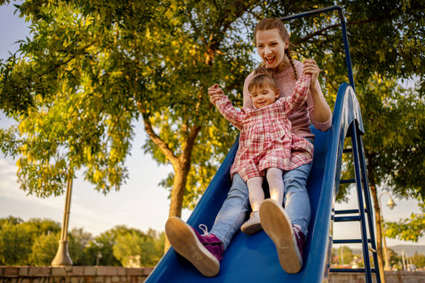 istock Mother with her daughter enjoying in playground 1270583225