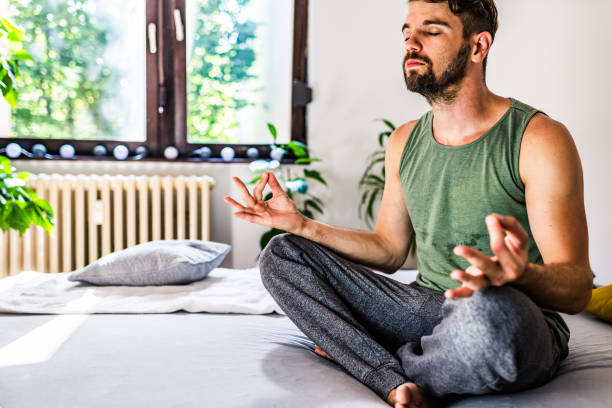istock Relaxed man practicing Yoga at home 1270583256