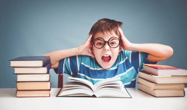 istock Seven years old child reading a book 1270583638