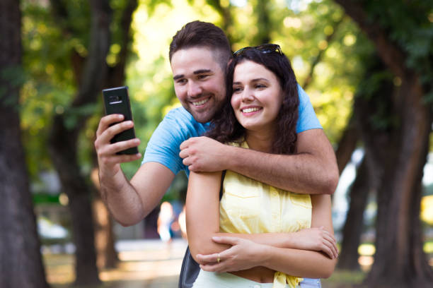 istock Couple taking selfie in the park 1270584387