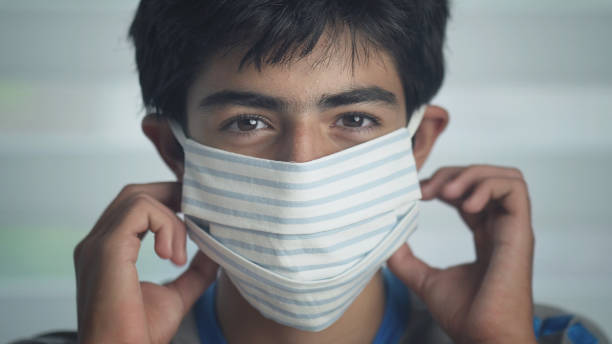 istock Cuban teen putting on a face mask 1270586536