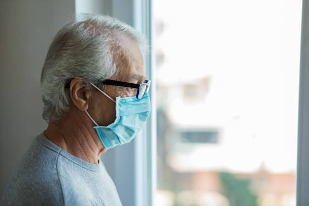 istock Senior man wearing a protective mask at home, 1270586785