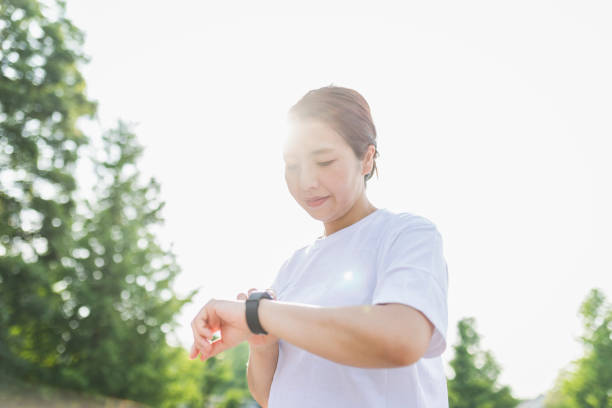 istock Woman using a smart watch while exercising in the park 1270587833