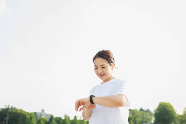 istock Woman using a smart watch while exercising in the park 1270587837