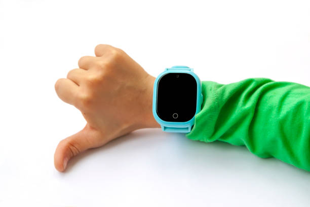 istock Blue smart digital watch on boy hand with green sleeve. Modern children technologies. GPS tracker for kids, child tracking and parental control concept. 1270588037