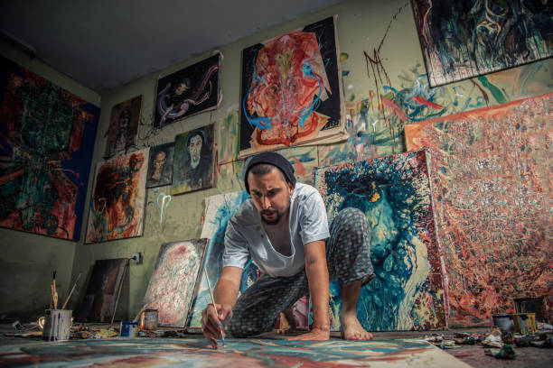 istock Artist- painter working on a new canvas in his art studio 1270588902