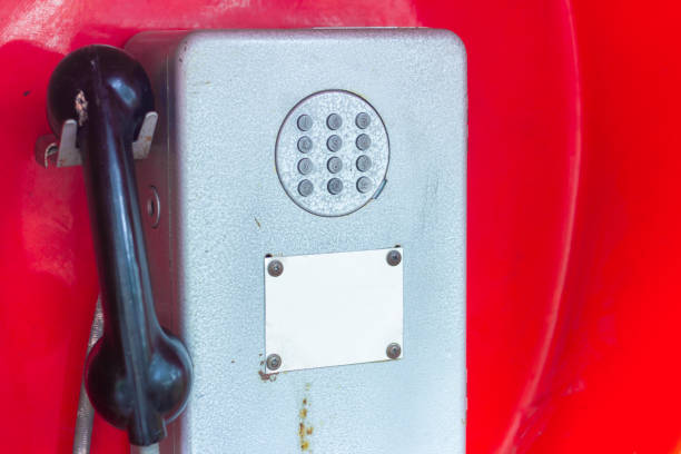 An old, rusty pay phone in the city