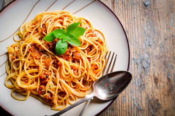 istock Italian spaghetti on rustic wooden table. Top view. 1270591099