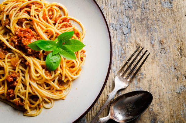 istock Italian spaghetti on rustic wooden table. Top view. 1270591619