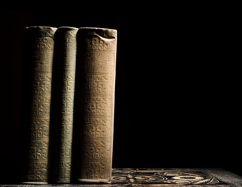 Old books in front of black background