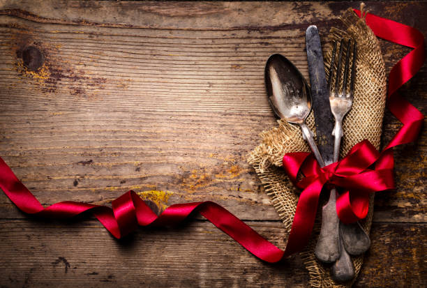 istock Vintage silverware decorated with red ribbon. Valentine's dinner setting background. 1270592396