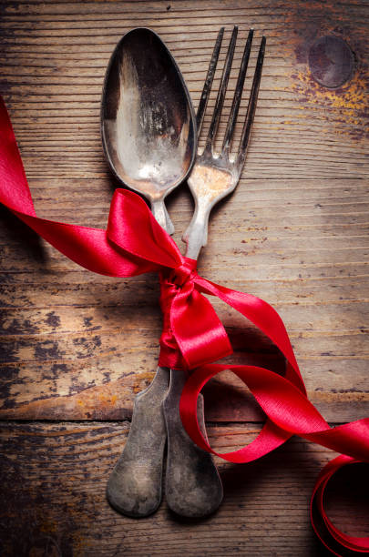 istock Vintage silverware decorated with red ribbon. Valentine's dinner setting background. 1270592563