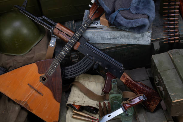 istock Kalashnikov AK 47 with ammunitions and vodka on army box background. 1270593301