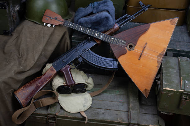 istock Kalashnikov AK 47 with ammunitions and balalaika on army box background 1270593329