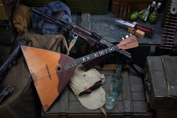 istock Kalashnikov AK 47 with ammunitions and vodka on army box background. 1270593364