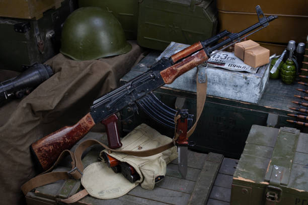 istock Kalashnikov AK 47 with ammunitions on army box background. 1270593377