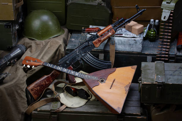 istock Kalashnikov AK 47 with ammunitions on army box background. 1270593396