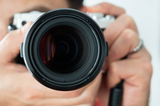 istock Man taking a photo holding a camera 1270593463