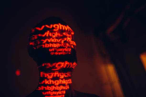 istock Young man with red letters on his face in the dark. 1270594800