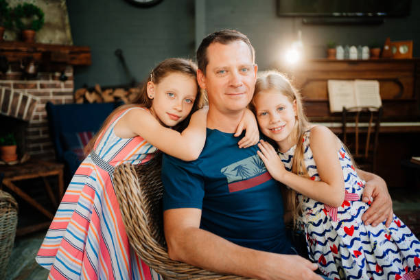istock dad hugs two daughters. father day. single father. 1270594881