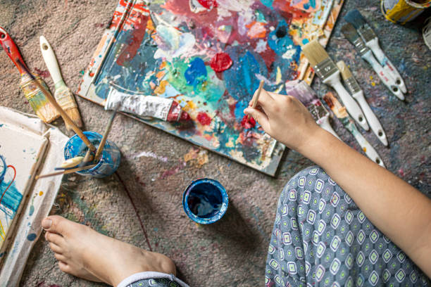 istock Young artist using a paintbrush to take paints from the palette 1270595016