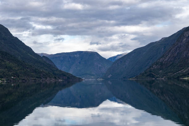 istock Heavy cloudy sky with reflection in lake 1270595059