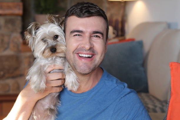istock Cute man holding little dog 1270595571