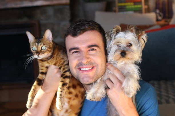 istock Man holding cat and dog 1270595763