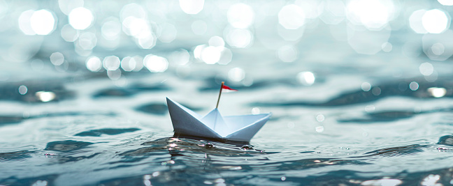 Paper Boat sailing on sea