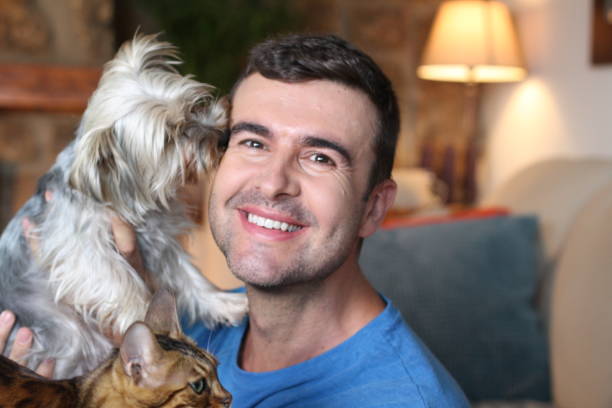 istock Man at home with cat and dog 1270596803