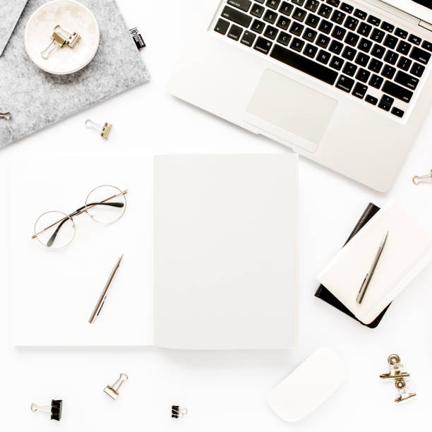 istock Home office workspace frame with laptop, clipboard, notebook and accessories on white background. Flat lay, top view 1270597976