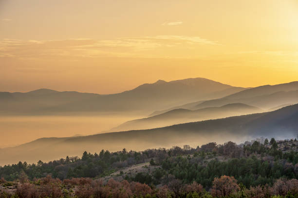 istock Sunset;  Foggy hills, trees and sky 1270598031