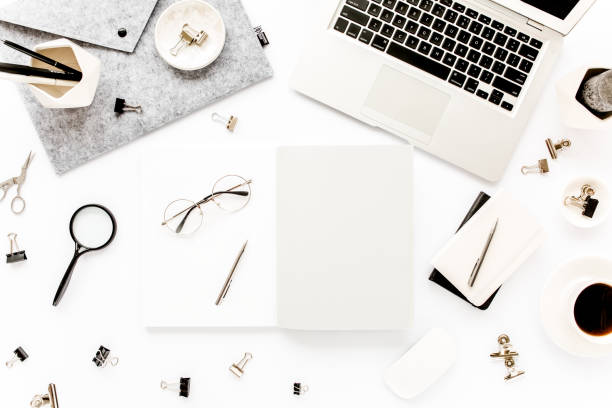 istock Home office workspace frame with laptop, clipboard, notebook and accessories on white background. Flat lay, top view 1270600186
