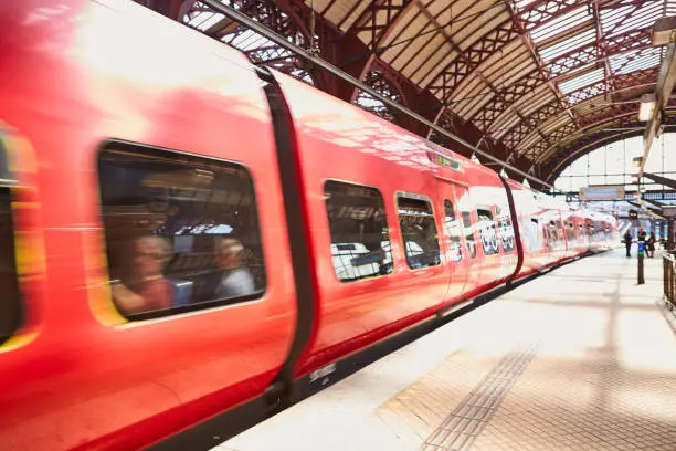 A train at a train-station going fast