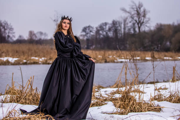 istock Mysterious Lady With Long Hair in Black Raincoat Posing In Forest outdoors.Horizontal image Orientation 1270600717