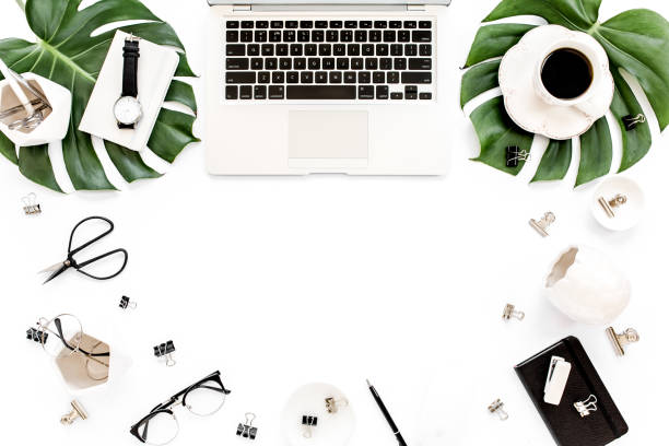 istock Home office workspace mockup with laptop, tropical leaves Monstera, clipboard, notebook and accessories on white background. Flat lay, top view 1270600830