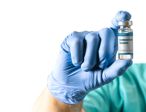 Doctor hold Medical bottle with Coronavirus Covid-19 Vaccine for injection on a white background.