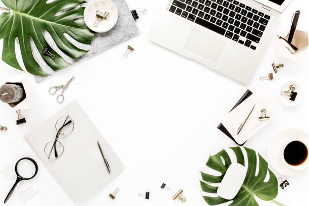 istock Home office workspace mockup with laptop, tropical leaves Monstera, clipboard, notebook and accessories on white background. Flat lay, top view 1270604162