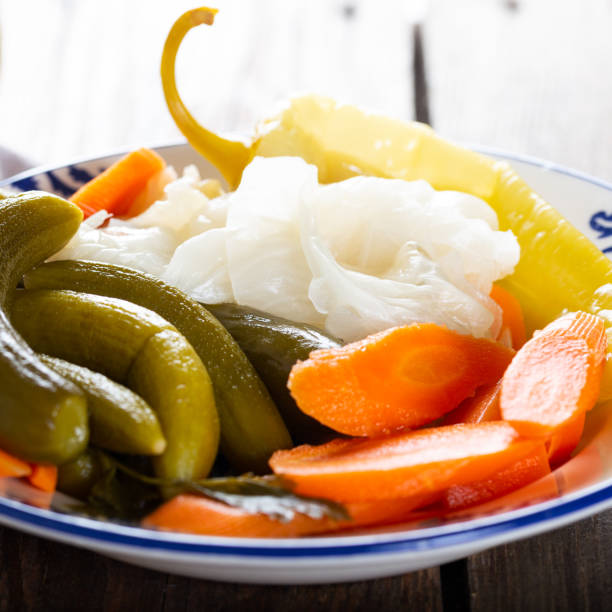 istock Assorted pickled vegetables in bowl/plate on natural wooden background. 1270604763